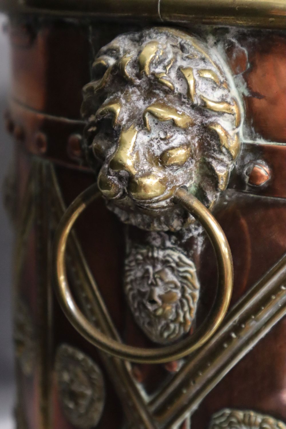 A Victorian copper and brass cylindrical coal box, with lion-mask ring handles, wood liner, 38cm